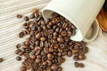 Coffee beans that spread out from a coffee cup