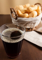 Brazilian starch biscuit in a basket with coffee in a american glass