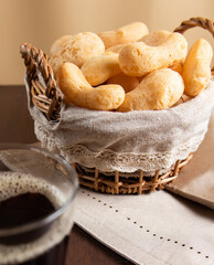Brazilian starch biscuit in a basket with coffee in a american glass