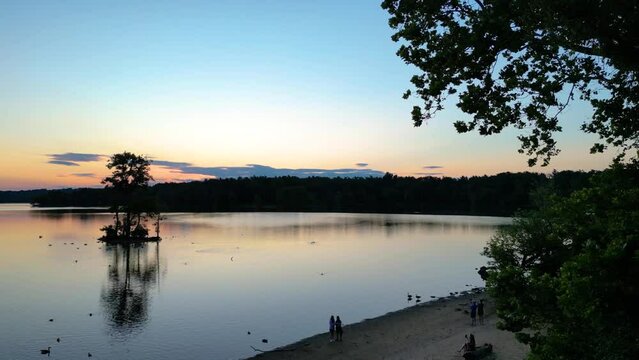 Drone footage of the Loch Raven Reservoir under dusk sky at sunset in Baltimore, Maryland, USA