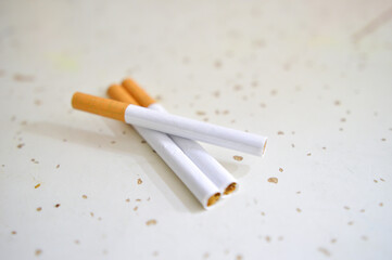 Cigarette isolated on a wooden background. Tobacco cigarette.