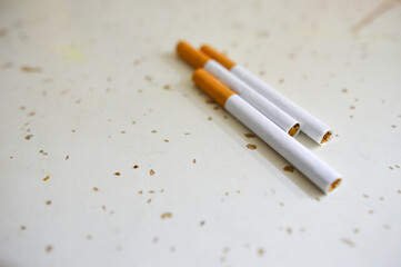 Close up of a cigarettes . Cigarette filter tubes on wooden background.