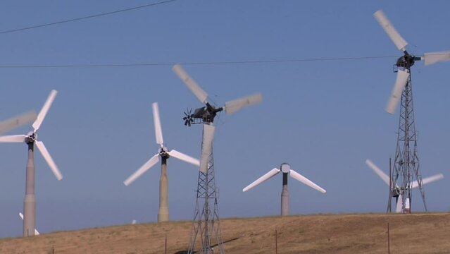 View of wind turbines working against blue sky in Altamont Pass wind farm, California, USA
