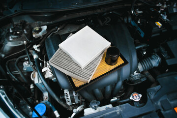 Car air filter and car oil filter on engine cover in engine compartment , Car spare parts concept