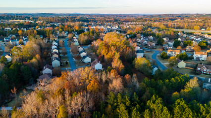 Aerial panoramic view of an upscale subdivision with housing cluster in suburbs of USA shot during golden hour - obrazy, fototapety, plakaty