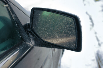 a side car mirror covered with ice, outdoor closeup