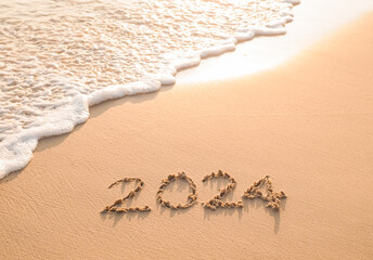 2024 year written on the beach in the sunset time. New Year 2024 concept - obrazy, fototapety, plakaty