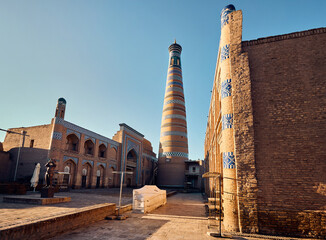 Old sqare with statue and Minaret in Ichan Kala of Khiva