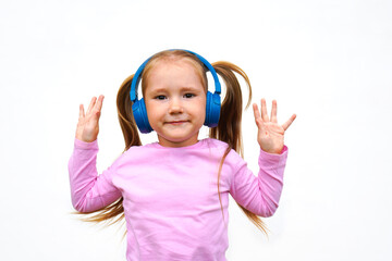 Carefree attractive girl with dark long hairstyle, listening music in headphones standing over white background