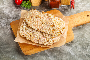 Breaded raw breaded meat schnitzel