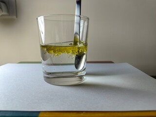 Mix olive oil with a spoon in water