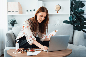 Young happy woman buy product by online shopping at home while ordering items from the internet with credit card online payment system protected by utmost cyber security from online store platform