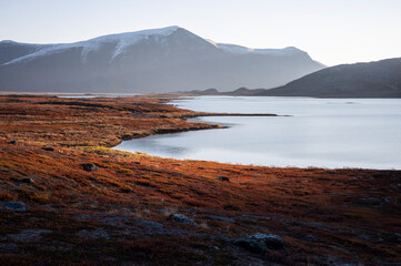 Autumn colors in the Swedish mountains by a lake on a beautiful September morning, Kiruna region, Swedish Lapland