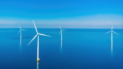 Windmill turbines with blue sky, windmill turbines in the ocean the biggest wind park in the Netherlands © Chirapriya