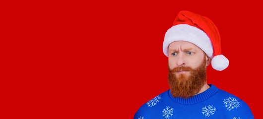 Xmas sweater. Christmas announcement. Happy New Year. Christmas holiday celebration. Santa man at New Year eve. December winter holiday party for man in Santa hat. Copy space