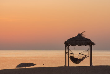 couple in a hammock at the beach waiting for the sunrise