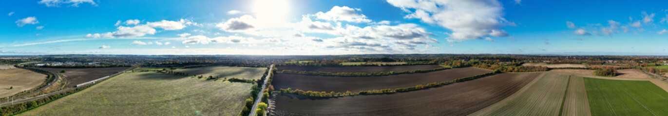 Fototapeta premium Aerial Ultra Wide Panoramic View of Countryside Landscape and Agricultural Farms of Letchworth Garden City of England UK