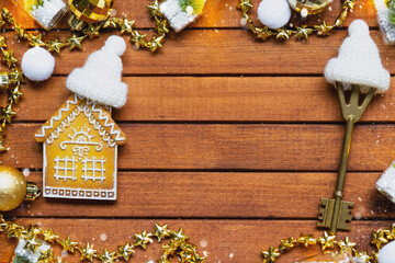 Tiny gingerbread house on wooden background with Christmas decor layout and copy space. Gift for...
