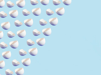 Eggshells on the blue background. Minimal creative concept. Easter pattern. Copy space.