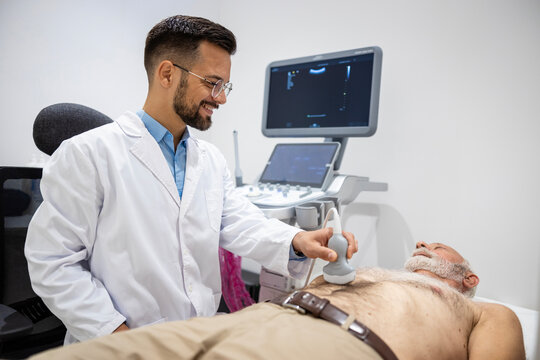 Doctor doing abdominal ultrasound checking the patient digestion system.