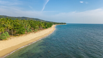 Aerial drone view of tropical beach from above, sea, sand and palm trees island beach landscape, Lanta, Thailand
