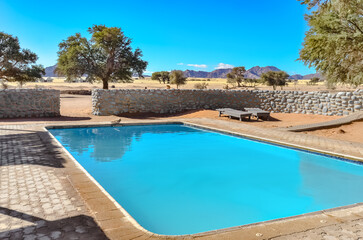 Swimming pool in luxury safari lodge camp in african savannah nature reserve, Namibia, South Africa
