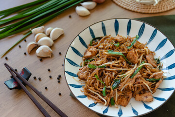 Closed up stir-fried noodle with black sauce and pork, traditional Thai food