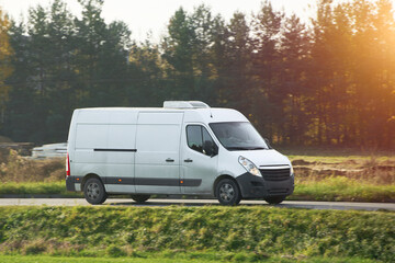 Banner image of white modern delivery shipment cargo courier van moving fast on the highway road to...