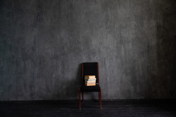One black chair with a gift in the interior of a room