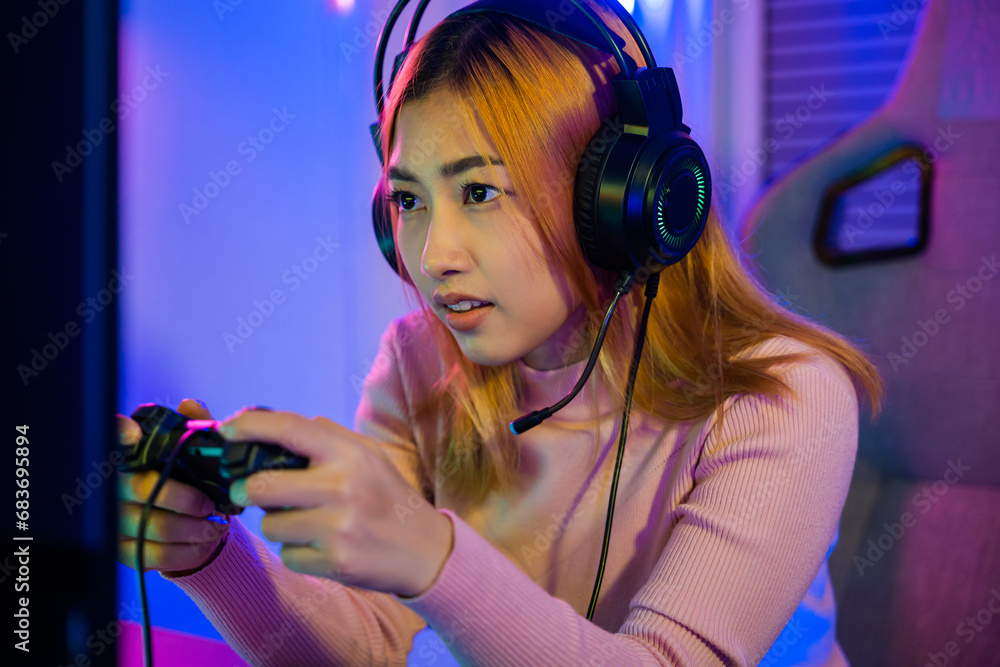 Aufkleber you win. gamer using joystick controller plays online video game with computer neon lights she winni