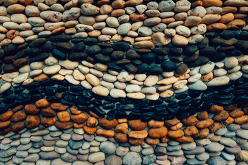Small round stones background. Stone texture. Rough surface of small pebble stone.