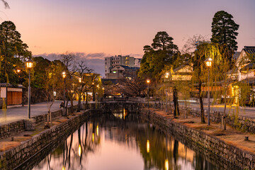 Kurashiki Bikan Historical Quarter in dusk. Townscape known for characteristically Japanese white walls of residences and willow trees lining banks of Kurashiki River. Okayama Prefecture, Japan - Powered by Adobe