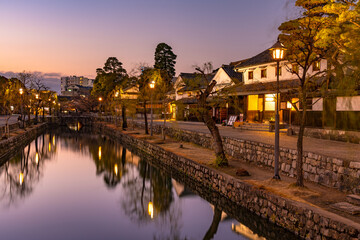 Kurashiki Bikan Historical Quarter in dusk. Townscape known for characteristically Japanese white...