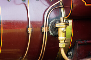 close up detail of a burgundy and black traction engine or steam-powered tractor