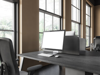 Coworking interior with pc computer on table with mockup display, window