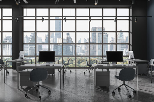 Gray open space office with small tables