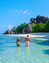 Anse Source d'Argent beach, La Digue Island, Seychelles, couple men and woman relaxing at the beach...