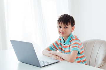 Boy doing online learning with laptop