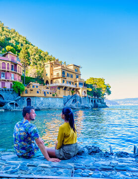 Beautiful sea coast with colorful houses in Portofino Italy Europe Portofino in Liguria Genoa Couple mid age man and woman visiting Italy during a vacation in the summer