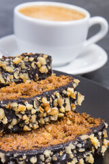 Zucchini dough on black plate and cup of white coffee. Delicious dessert