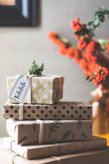 Stack of Christmas gifts on table, fa la la la gift tag