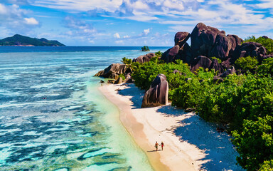 Anse Source d'Argent, La Digue Seychelles, a young couple of Caucasian men and Asian women on a...