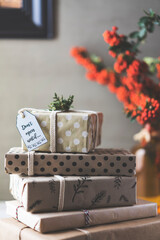 Stack of Christmas gifts on table, don't open until