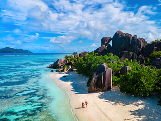 Anse Source d'Argent, La Digue Seychelles, a young couple of men and women on a tropical beach during a luxury vacation in Seychelles