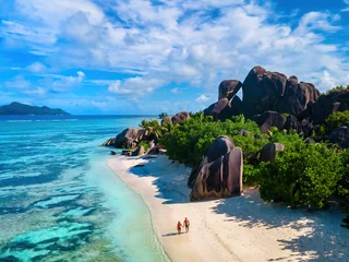 Foto op Plexiglas Anse Source d'Argent, La Digue Seychelles, a young couple of men and women on a tropical beach during a luxury vacation in Seychelles © Fokke Baarssen