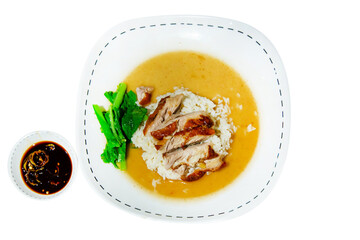 Top view of Roasted duck topping on thai rice with gravy sauce on white background.