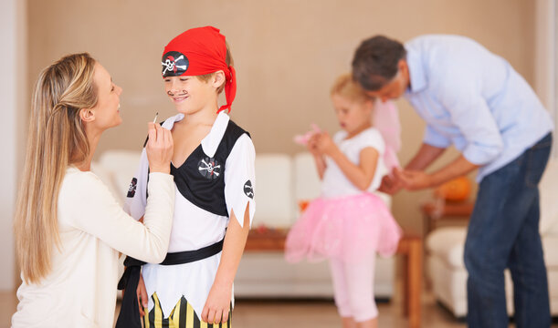 Boy, pirate costume and halloween with mother in home, face paint and happiness in childhood. Son, smile and house birthday with party clothes by woman, love family and celebration together with care