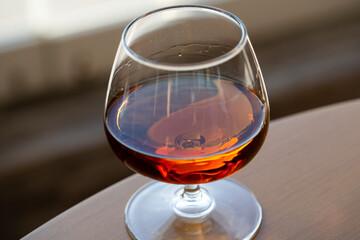 glass of cognac on a wooden table in the bar.