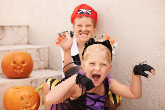 Siblings, portrait and halloween costume by outdoor, theme paint and happiness in childhood. Boy, girl or scary face for holiday party event with pumpkin, excited fairy or pirate by backyard stairs
