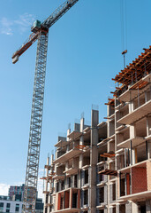 Construction site with crane. Building process of condominium, multi-story block of flats